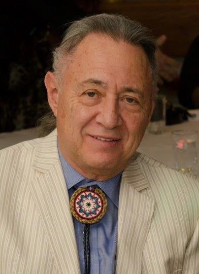 Headshot of Board Member, Maurice Switzer in a suit and Indigenous bolo tie