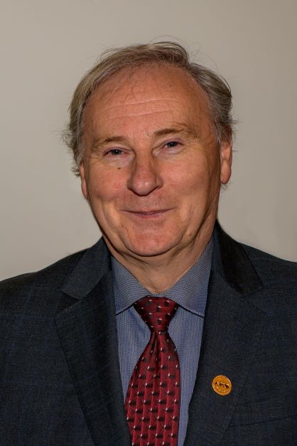Headshot of Board Member, Jamie McGarvey in a suit and tie