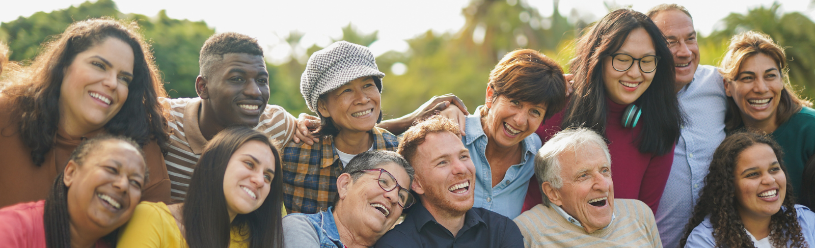 Image of a big group of diverse people smiling, laughing and connecting while posing for a picture