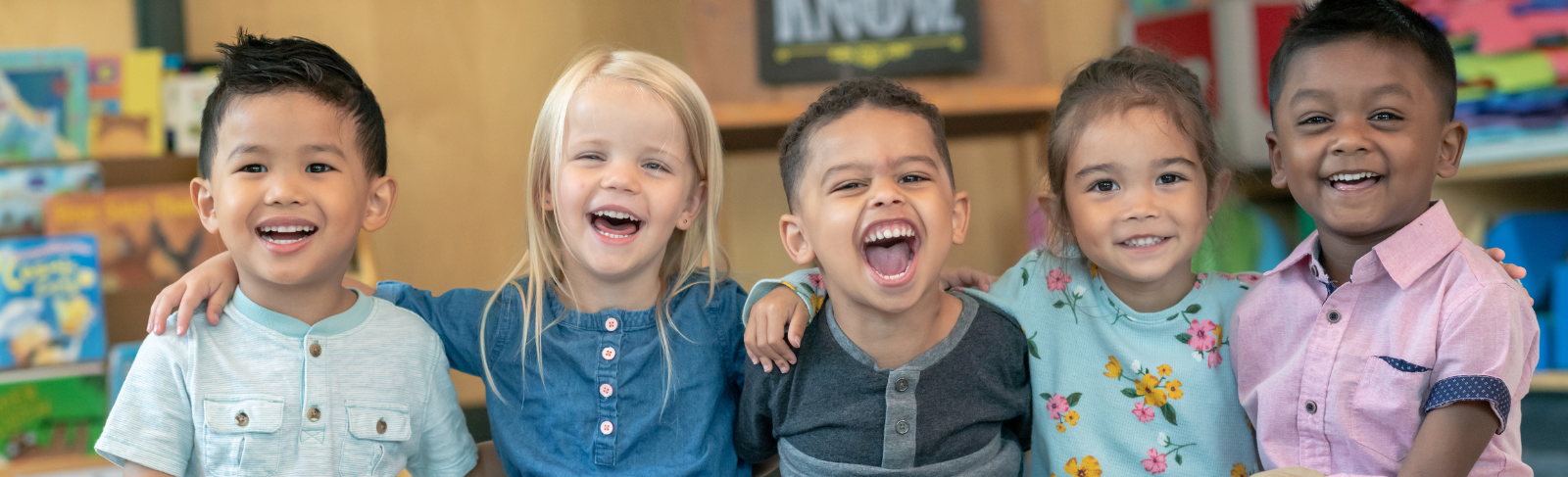 Image of happy toddlers sitting in a row