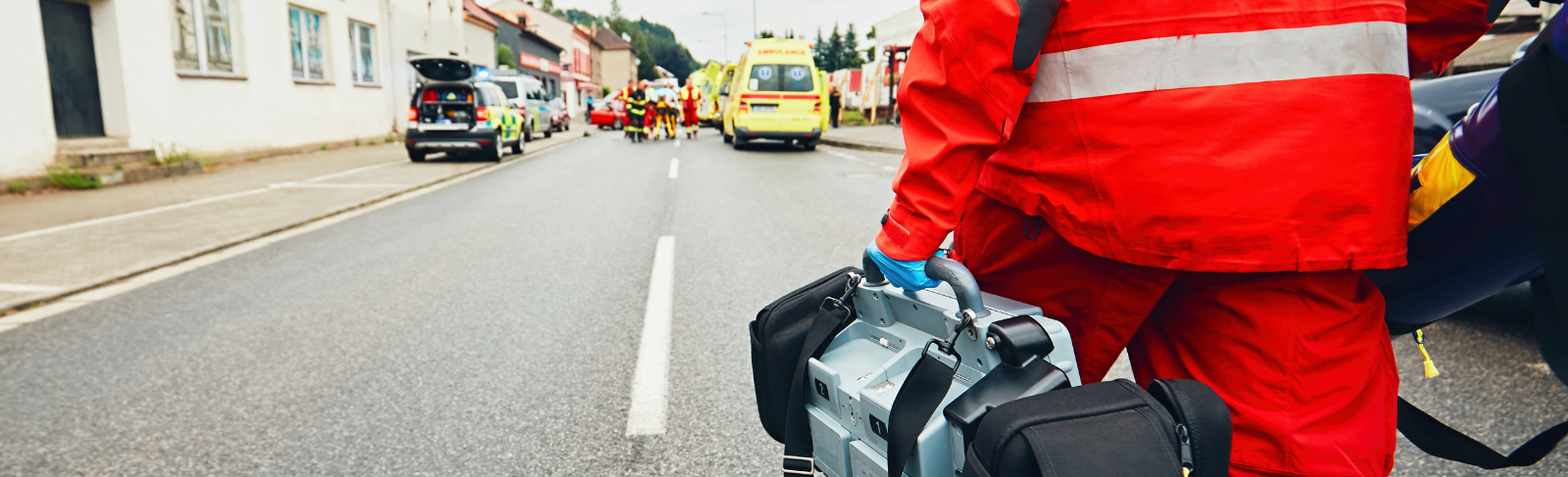 Image of resources being carried by a first responder walking to an emergency scene