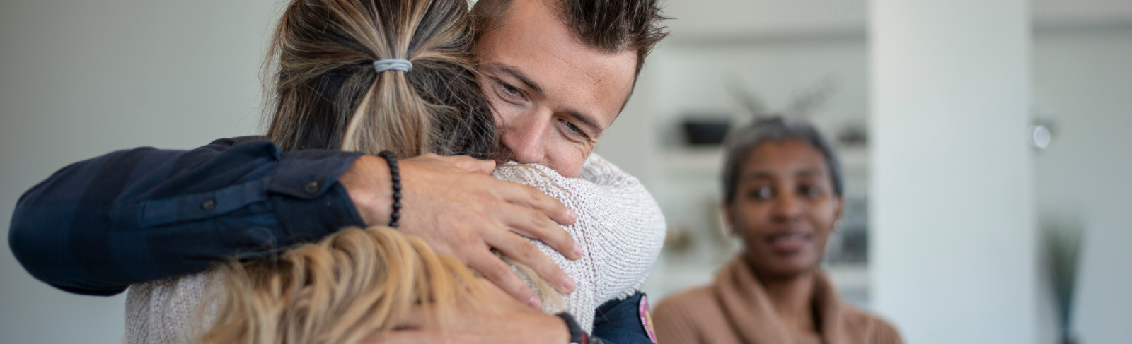Image of two people embraced in a hug