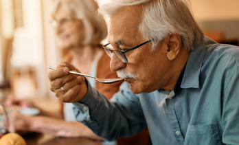 Older adult eating soup