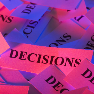 Words on pieces of papers saying decisions