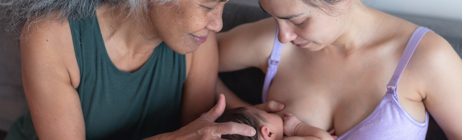 Woman breastfeeding with supportive mother
