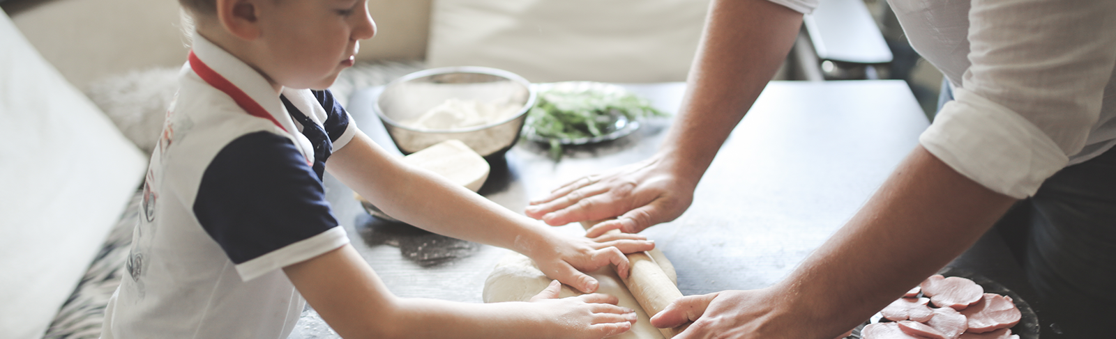 Father and son making pizza
