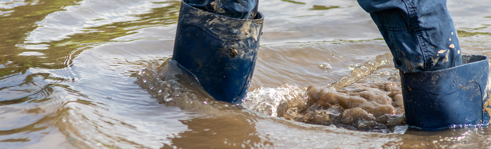 Flood water with someone in rubber boots 