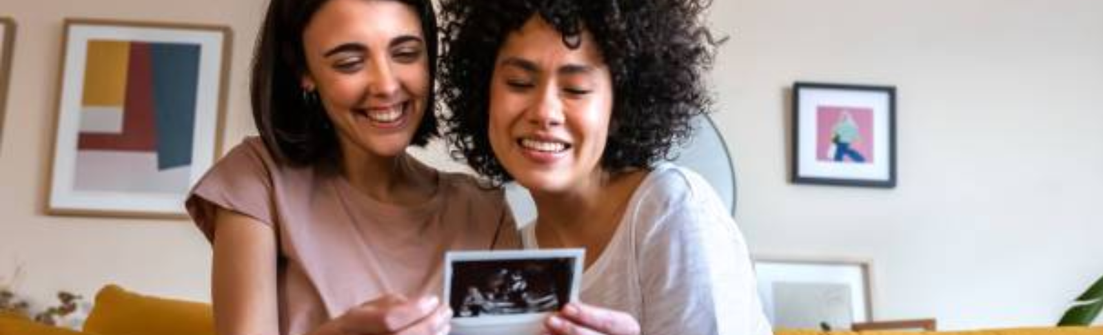 Two people smiling at an utrasound photo
