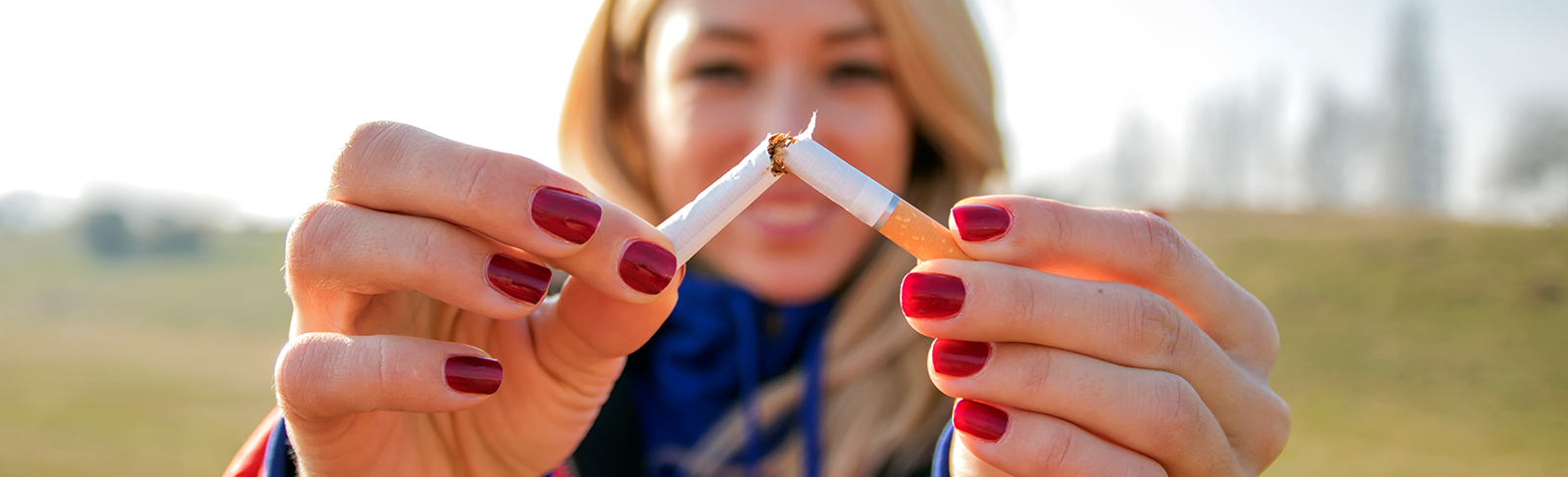 Lady breaking cigarette in half