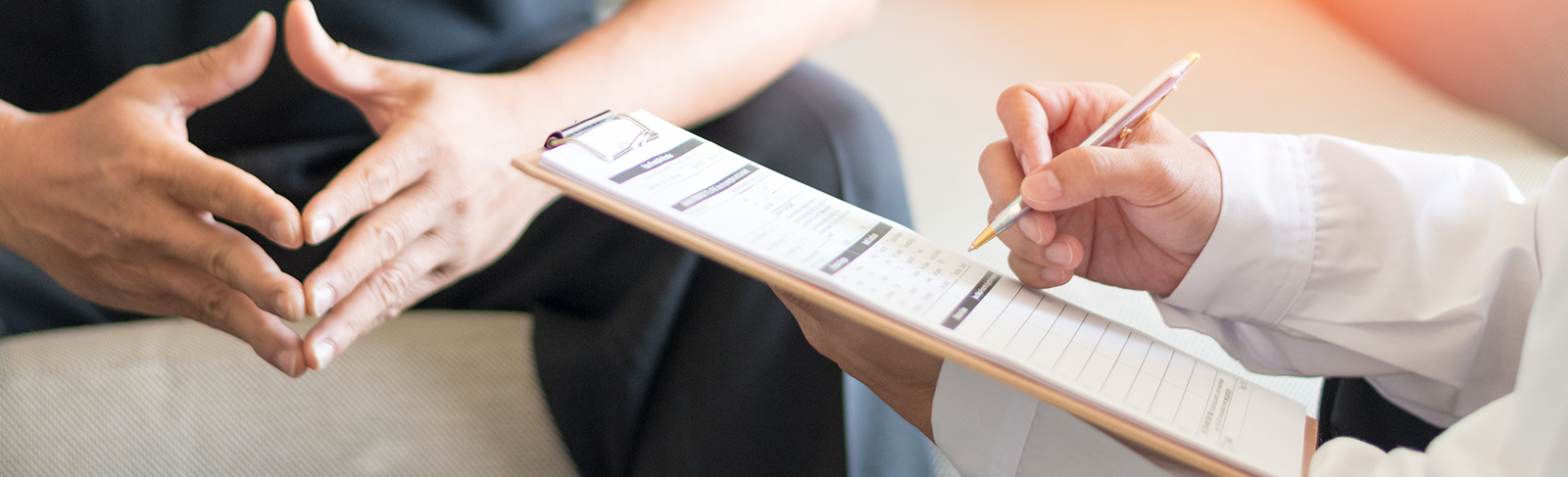 Person sitting on a bench with with someone doing intake.
