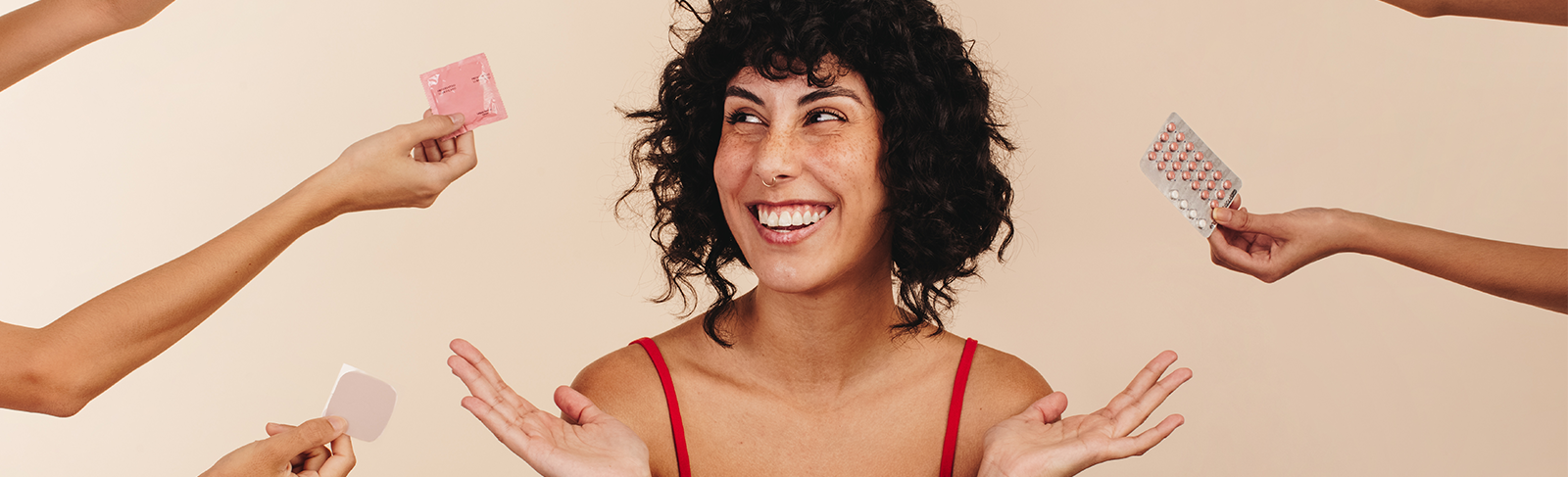 Women with brown curly hair with birth control options around her.