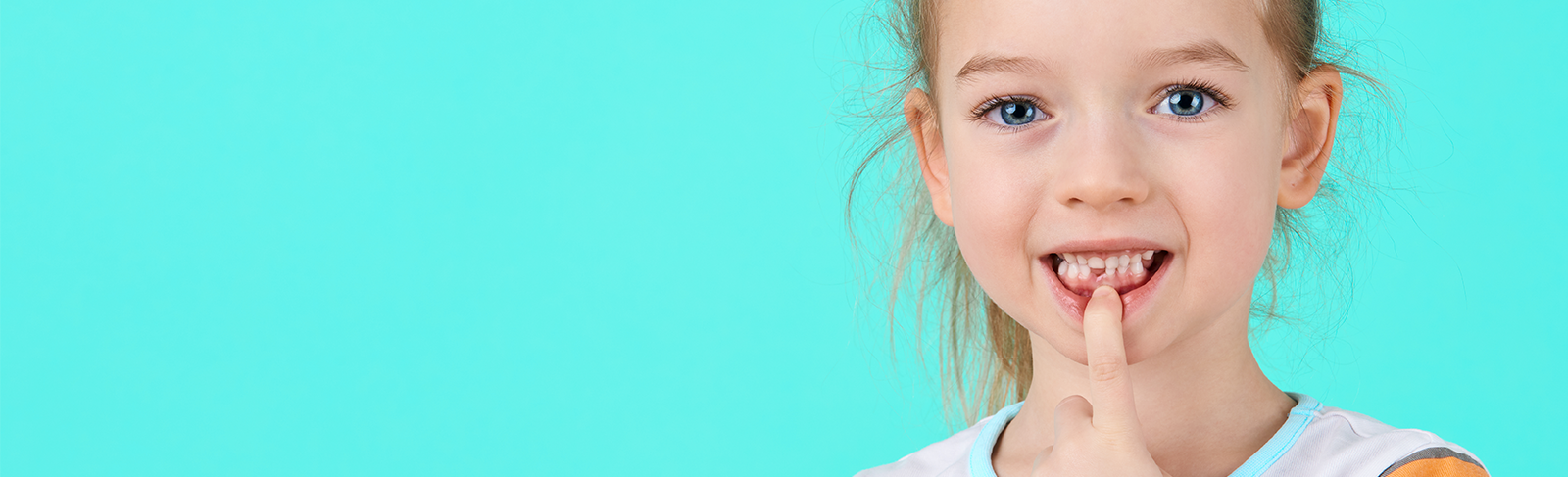 Girl showing her teeth with a blue background