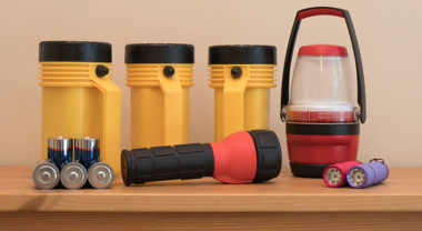 Image of flashlights, batteries and a lantern