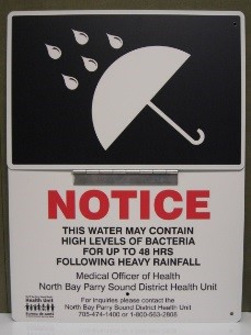 signage indicating rainfall warning for public swimming
