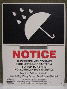 Rainfall warning signage indicating rainfall warning for public swimming
