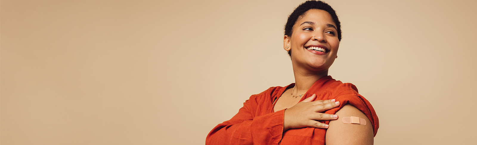 Person in red with their sleeve rolled up