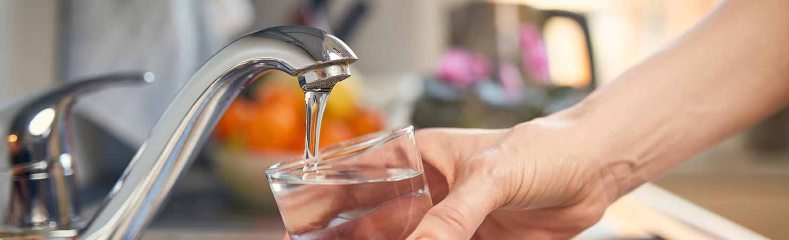 Tap with water running into the glass