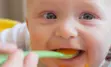 Baby being spoon-fed.