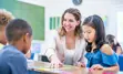 Image of a teacher connecting with a small group of students in a classroom setting