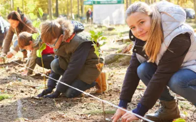 Youth and adults planting trees 