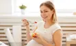 Pregnant person eating a fruit salad