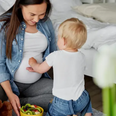 Pregnant woman bonding with toddler